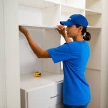 handyperson installing closet shelves