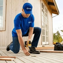 handyman from Handyman Connection repairing old deck boards