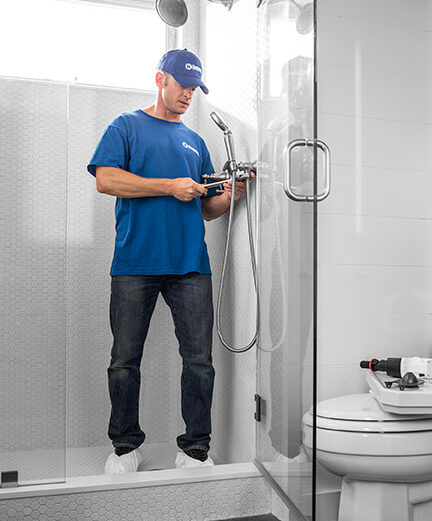 handyman installing new plumbing fixture for bathroom