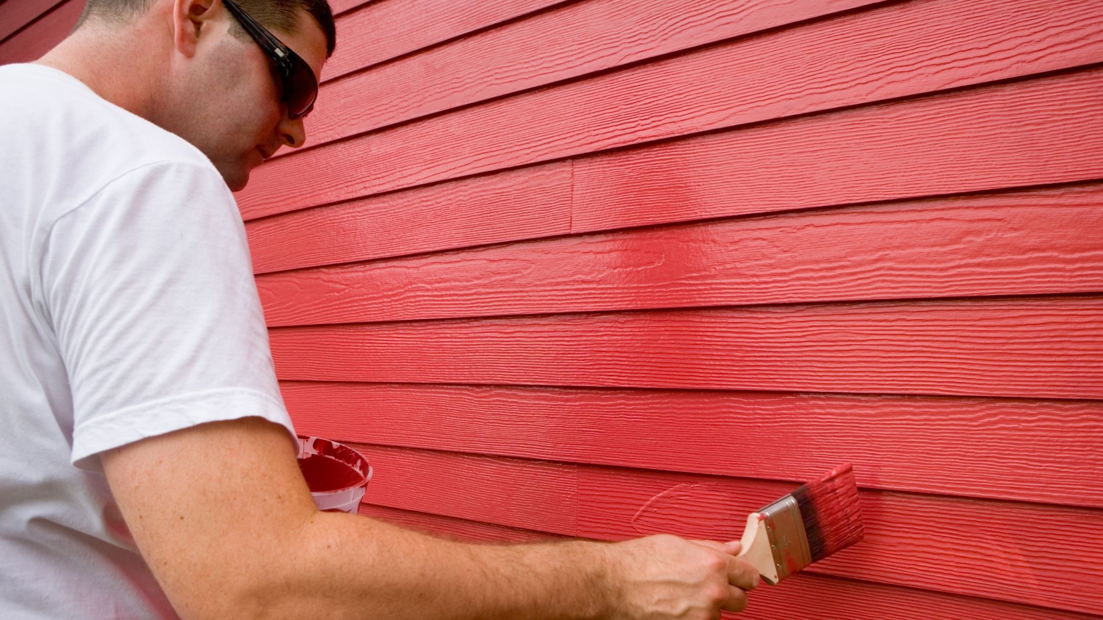 man painting a house