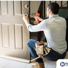 handyman replacing front door of home