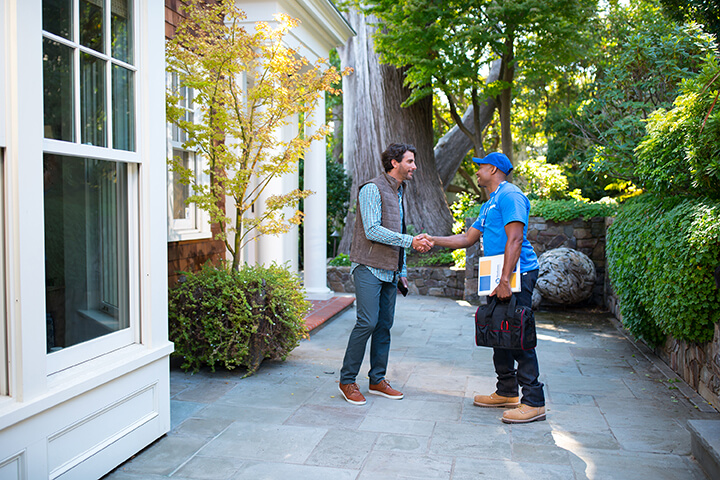 handyman from Handyman Connection shaking hands with homeowner